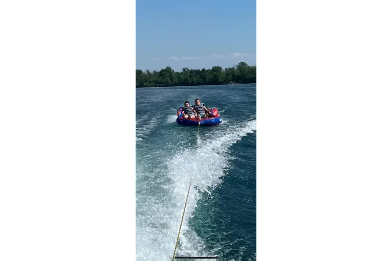 Slide: The Image of People tubing on a lake, towed by a 2020 Monterey 278SS Super Sport boat. - 13