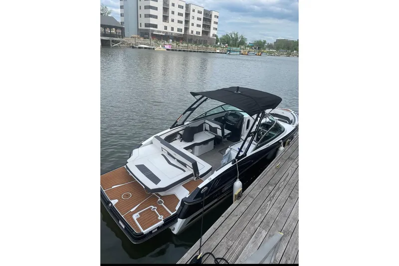 Slide: The Image of 2020 Monterey 278SS Super Sport boat docked by waterfront buildings. - 2