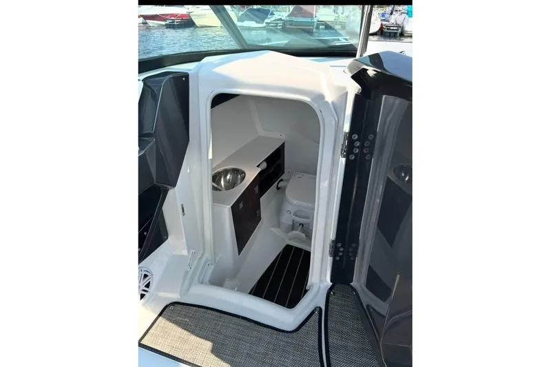 Slide: The Image of Interior of 2020 Monterey 278SS Super Sport boat with compact bathroom amenities. - 9