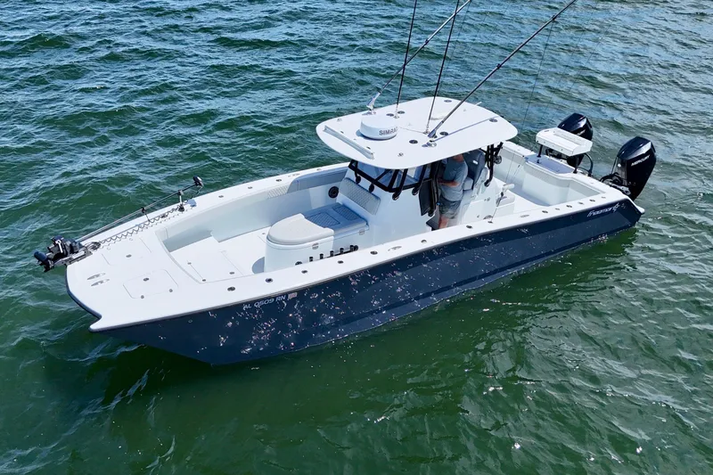 Slide: The Image of 2023 Freeman 34VH boat on water, featuring dual outboard motors and fishing rods. - 10