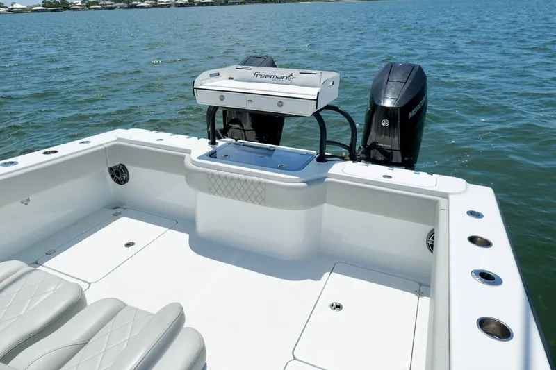 Slide: The Image of 2023 Freeman 34VH boat with dual engines on calm water. - 14