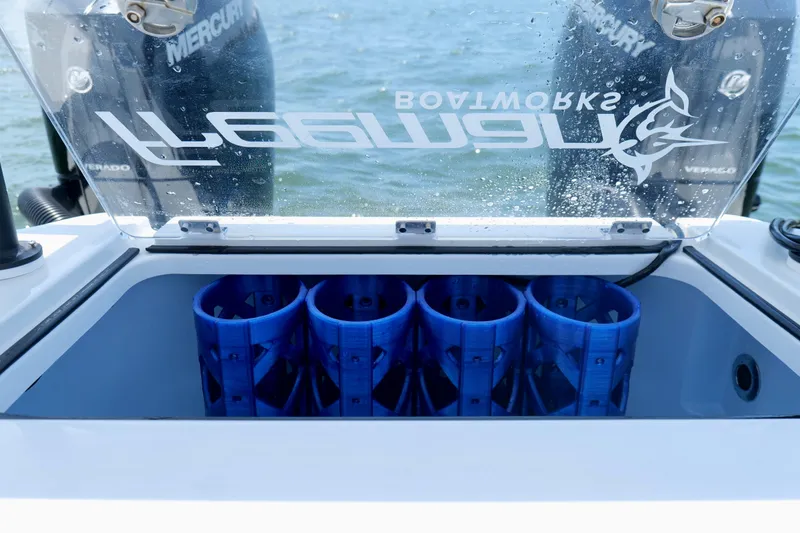 Slide: The Image of Freeman 34VH boat's livewell with blue inserts, 2023 model, on water. - 15