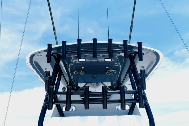 Slide: The Image of Freeman 34VH 2023 boat with rod holders and antennas against a clear sky. - 18