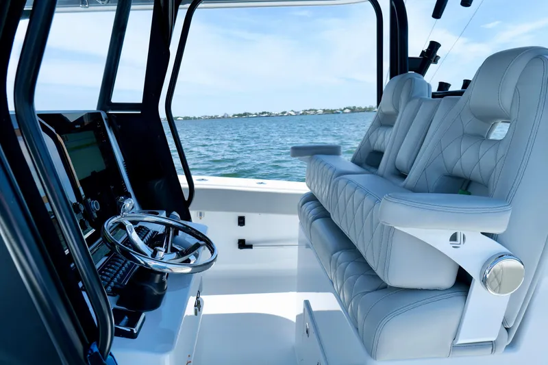 Slide: The Image of Interior of 2023 Freeman 34VH boat with luxurious seating and steering wheel. - 19