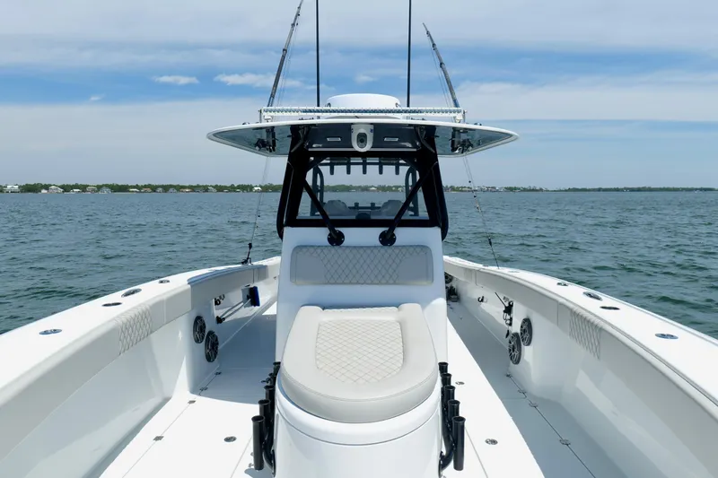 Slide: The Image of 2023 Freeman 34VH boat on open water, showcasing sleek design and spacious deck. - 2