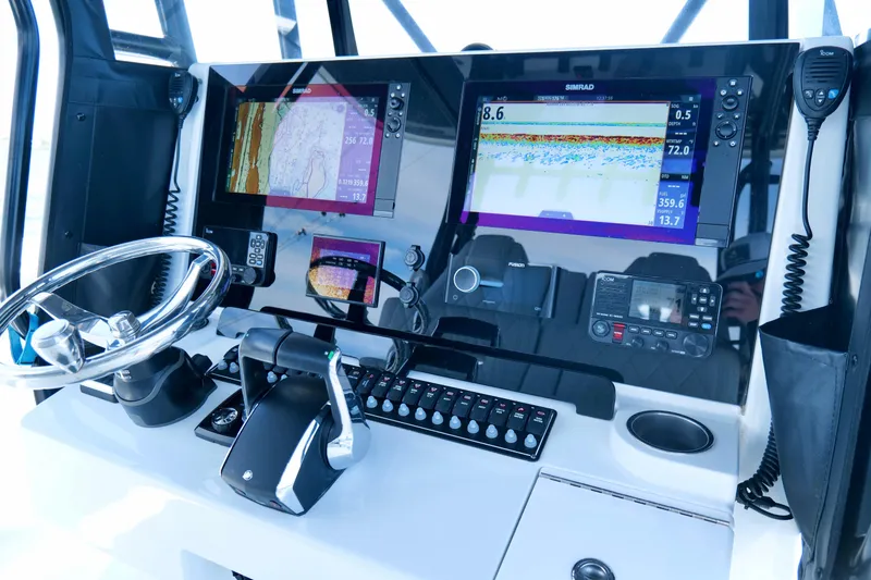Slide: The Image of Control panel of 2023 Freeman 34VH boat with advanced navigation systems and steering wheel. - 24