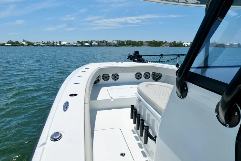 Slide: The Image of 2023 Freeman 34VH boat on water, showcasing sleek design and spacious deck. - 26