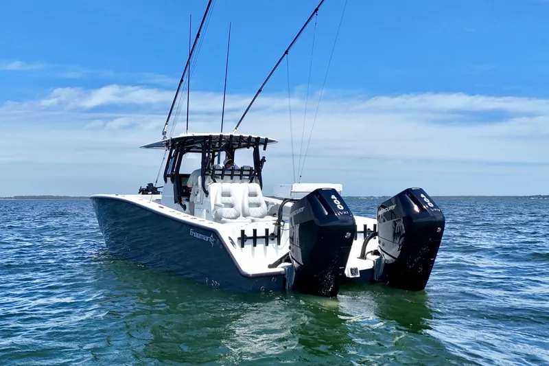 Slide: The Image of 2023 Freeman 34VH boat with dual Mercury engines on open water. - 3