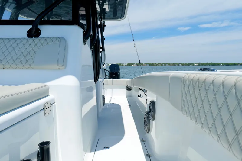 Slide: The Image of 2023 Freeman 34VH boat interior with quilted seating, ocean view, and fishing rod holders. - 36