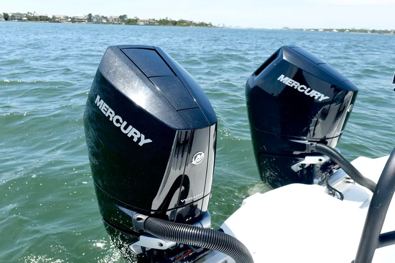 Slide: The Image of Twin Mercury outboard engines on a 2023 Freeman 34VH boat in open water. - 37