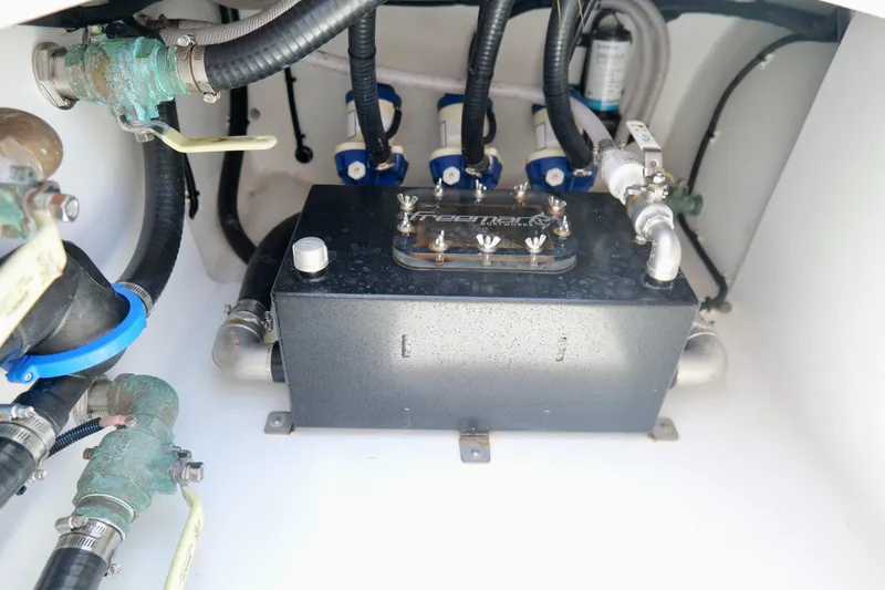 Slide: The Image of Engine compartment of a 2023 Freeman 34VH boat, showcasing mechanical components and piping. - 39