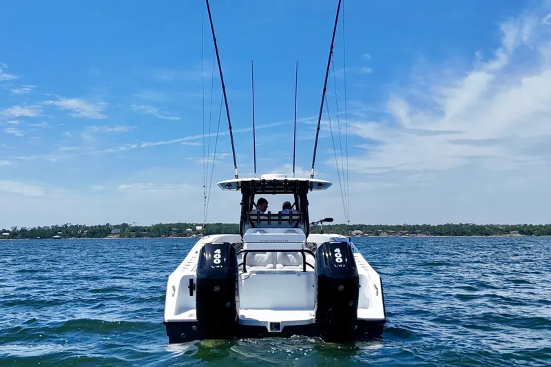 Slide: The Image of 2023 Freeman 34VH boat on water, featuring dual 400 V8 engines, under a clear blue sky. - 9