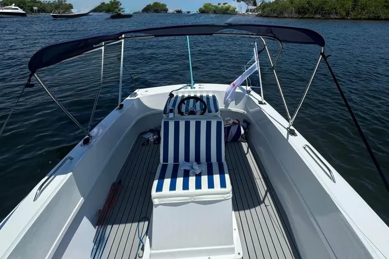 Slide: The Image of 1968 Donzi 18 Classic boat with striped seating, cruising on a serene lake. - 5