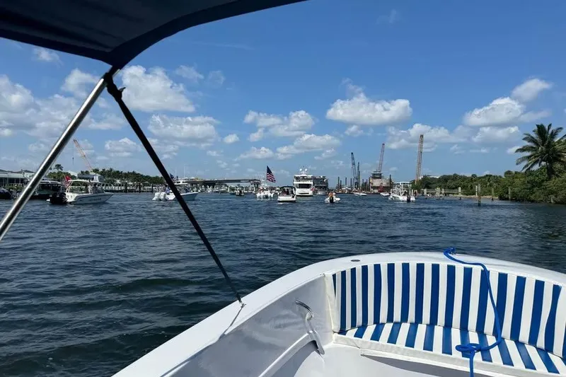 Slide: The Image of 1968 Donzi 18 Classic boat on a sunny day, cruising through a busy waterway. - 6