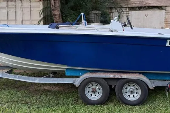 Slide: The Image of 1968 Donzi 18 Classic boat on trailer, blue hull, parked on grass. - 8