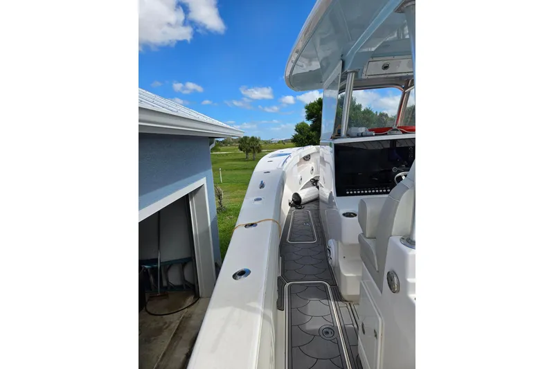 Slide: The Image of 2021 Streamline 35 CC boat docked beside a house under a clear blue sky. - 12