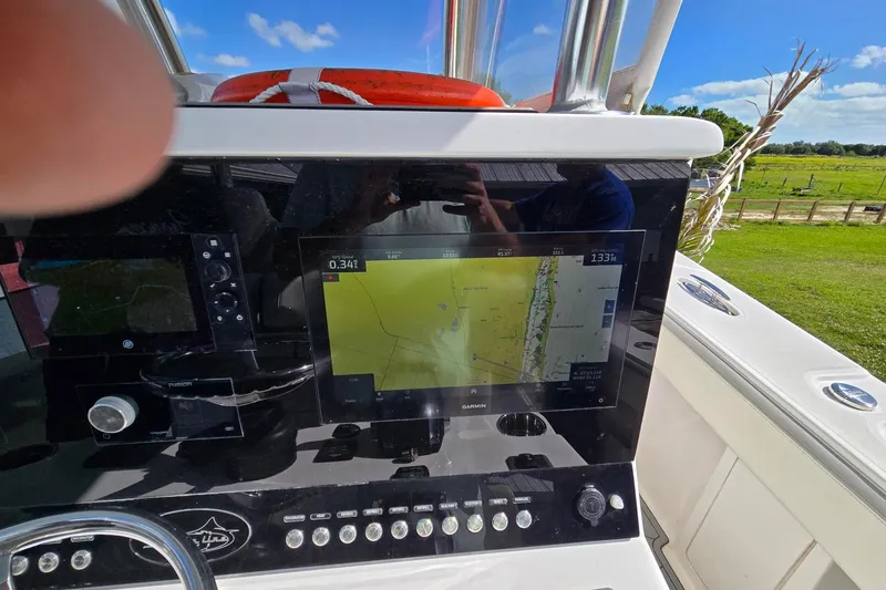 Slide: The Image of starboard Garmin display recessed mounted in black dash with all push button controls easily accessible - 4