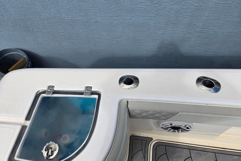 Slide: The Image of 2021 Streamline 35 CC boat deck with rod holders and storage compartment. - 8