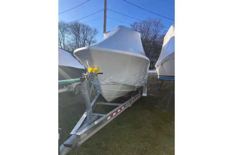 Slide: The Image of 2006 Regulator 24 Forward Seating boat covered on a trailer, outdoors in winter storage. - 10
