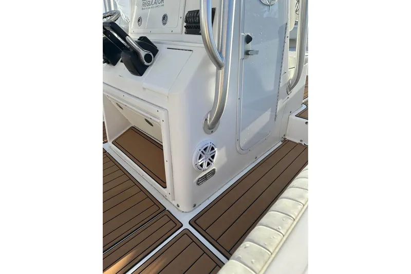 Slide: The Image of 2006 Regulator 24 Forward Seating boat interior with teak flooring and control panel. - 4