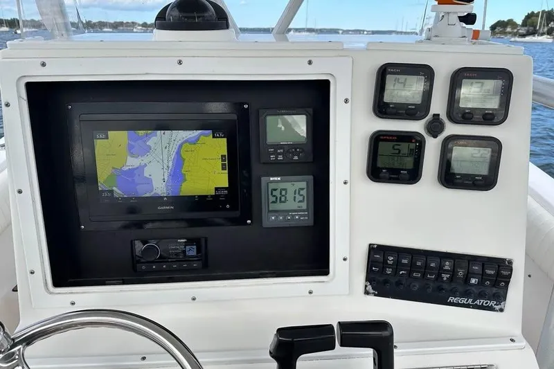 Slide: The Image of Control panel of a 2006 Regulator 24 Forward Seating boat with navigation and gauges. - 5