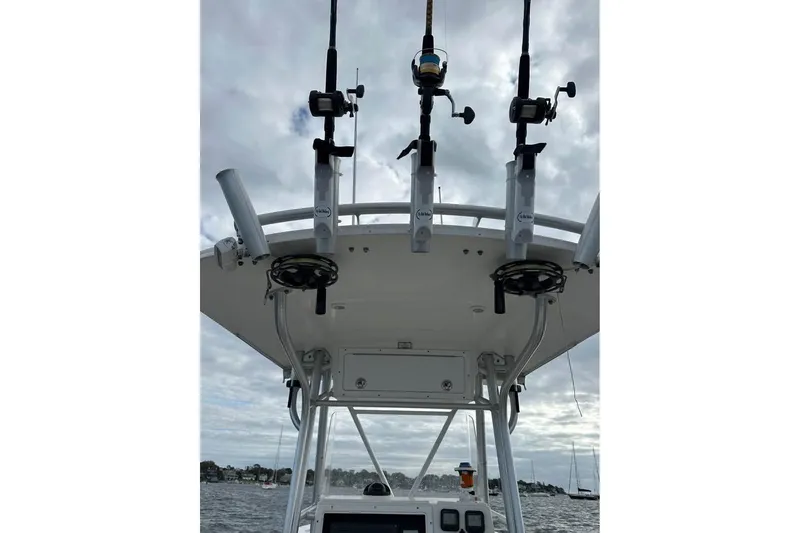 Slide: The Image of 2006 Regulator 24 Forward Seating boat with fishing rods on a cloudy day. - 6