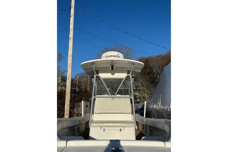 Slide: The Image of 2006 Regulator 24 Forward Seating boat with Garmin equipment, docked under clear blue sky. - 7