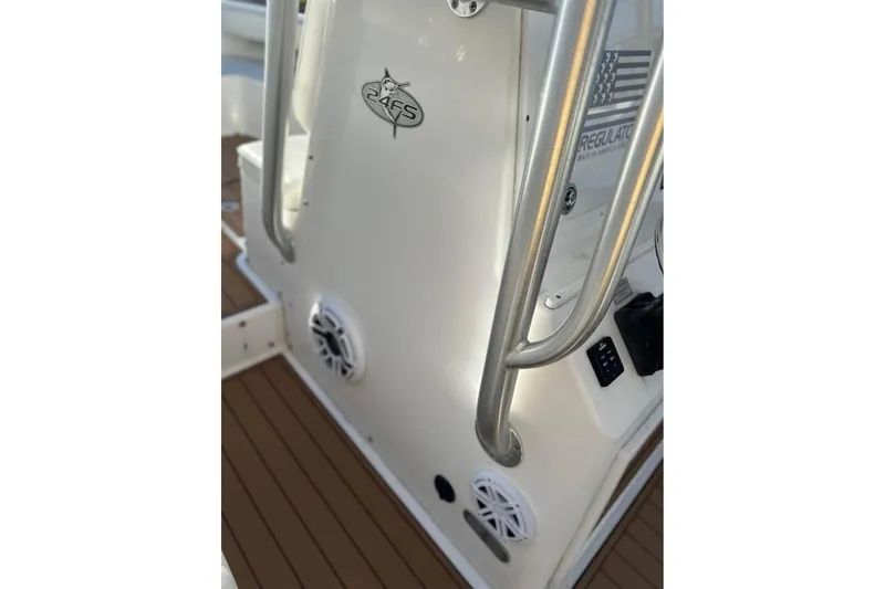 Slide: The Image of 2006 Regulator 24 Forward Seating boat interior with stainless steel railings and speakers. - 9