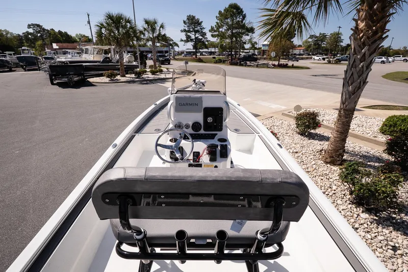 Slide: The Image of Avid 21 Mag 2026 boat with Garmin navigation, parked near palm trees. - 12