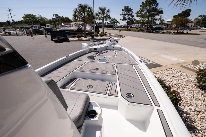 Slide: The Image of 2026 Avid 21 Mag boat with sleek deck design in a sunny outdoor setting. - 16
