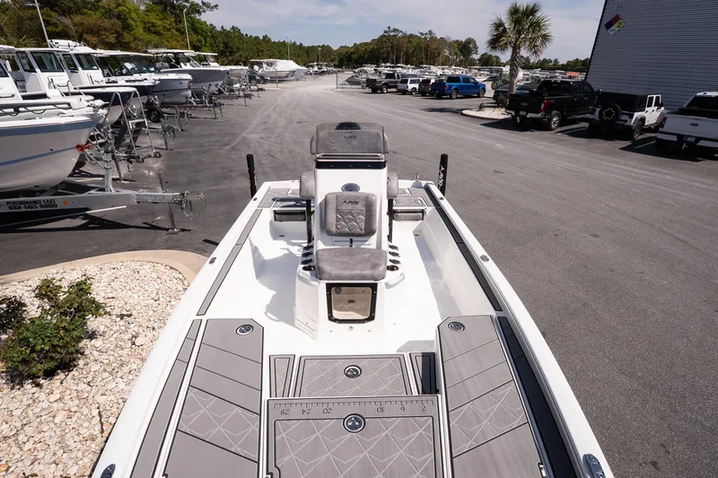 Slide: The Image of Avid 21 Mag 2026 boat on display at a dealership with other boats and vehicles. - 18