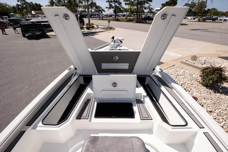 Slide: The Image of Open storage compartments on a 2026 Avid 21 Mag boat, parked outdoors. - 20