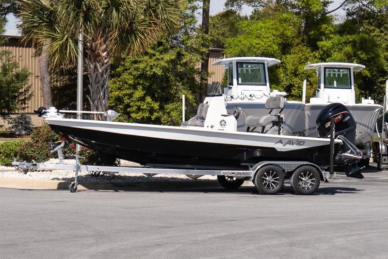 The Image of Avid 21 Mag 2026 boat on trailer, parked outdoors near trees. - 7