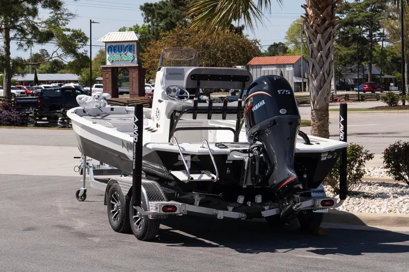 Slide: The Image of Avid 21 Mag boat with Yamaha 175 engine on trailer, parked near Neuse Sport Shop. - 9