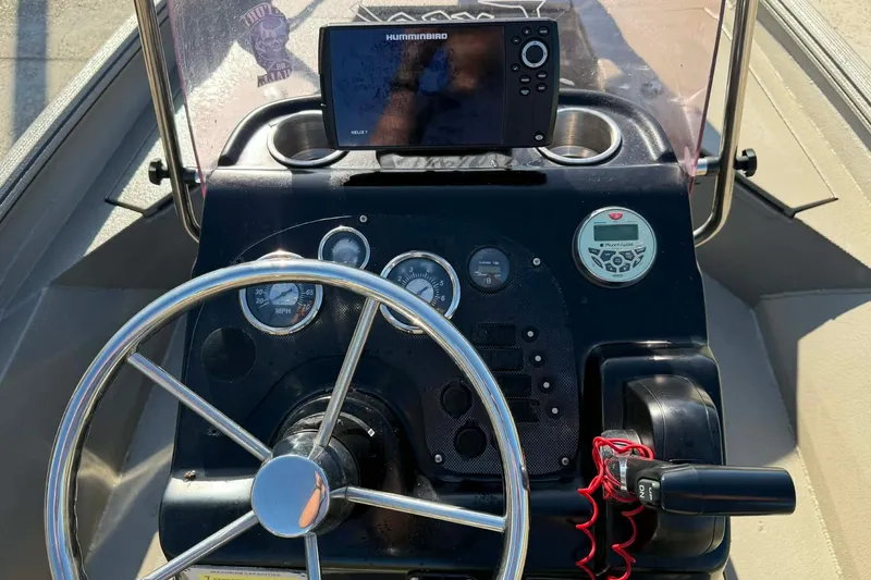 Slide: The Image of Console of 2020 Excel 203 Bay Pro boat with steering wheel and navigation system. - 10