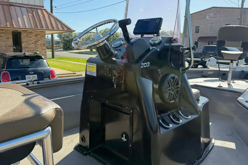 Slide: The Image of 2020 Excel 203 Bay Pro boat console with steering wheel and navigation equipment. - 15