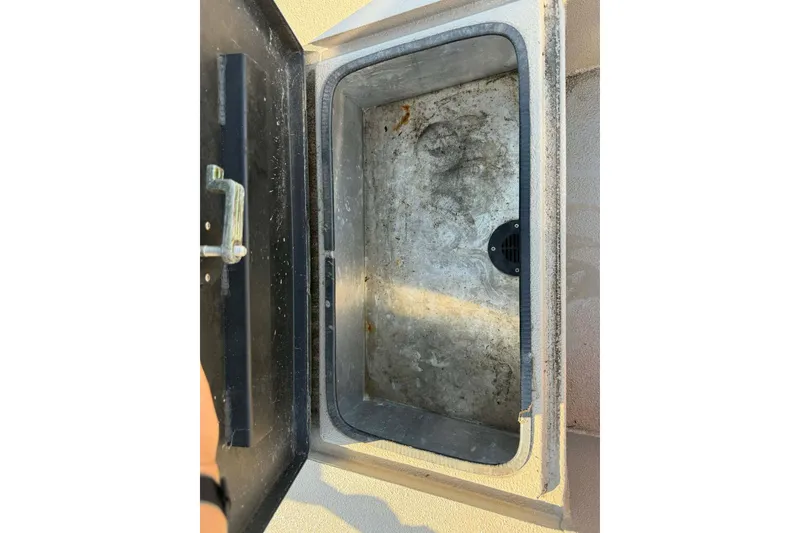 Slide: The Image of Open storage compartment on a 2020 Excel 203 Bay Pro boat. - 17