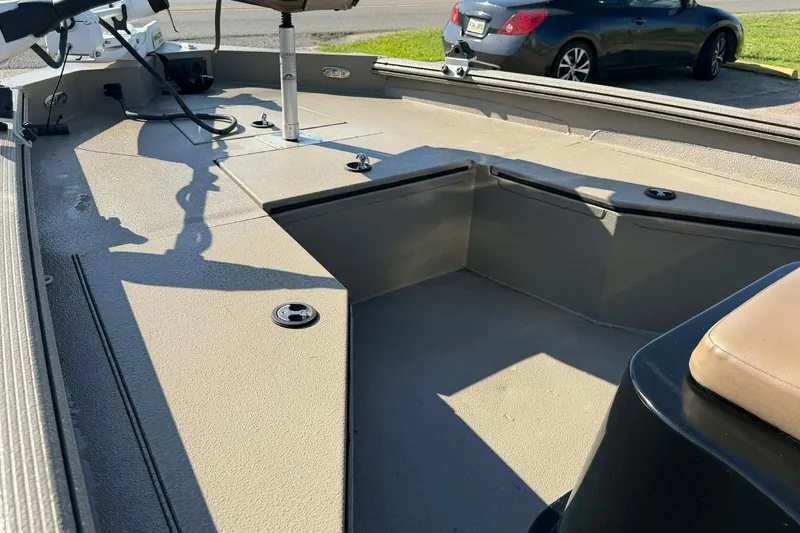 Slide: The Image of 2020 Excel 203 Bay Pro boat interior with seating and storage compartments. - 4