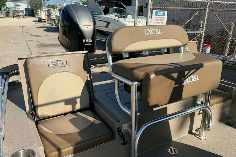 Slide: The Image of 2020 Excel 203 Bay Pro boat seats with Yamaha 115 engine in a marina setting. - 6