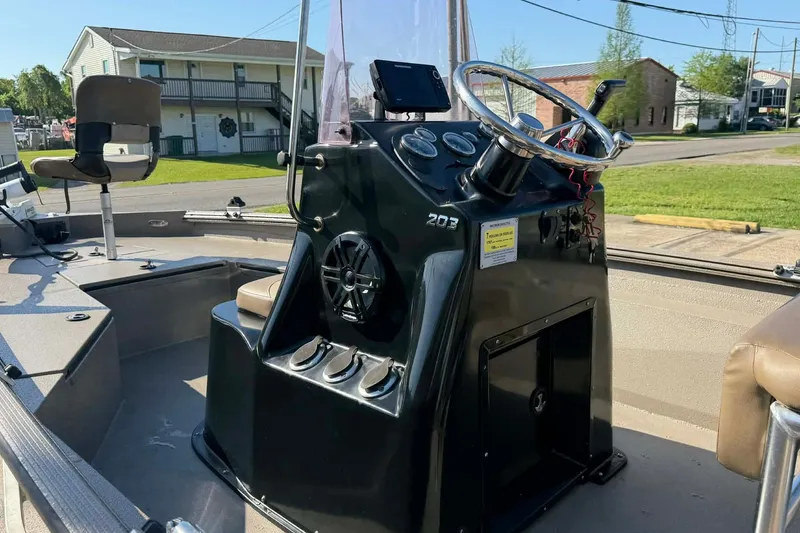 Slide: The Image of 2020 Excel 203 Bay Pro boat interior with steering console and seating. - 9