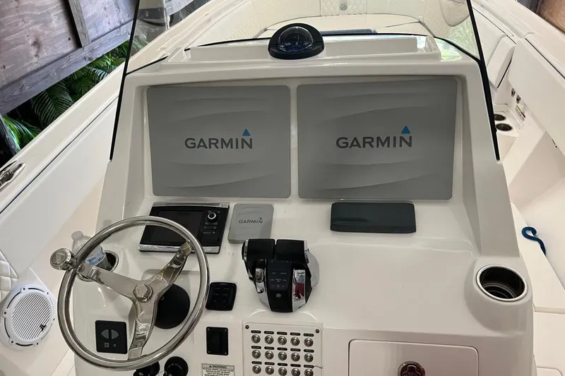 Slide: The Image of 2016 Intrepid 327 Center Console helm with dual Garmin displays and steering wheel. - 5