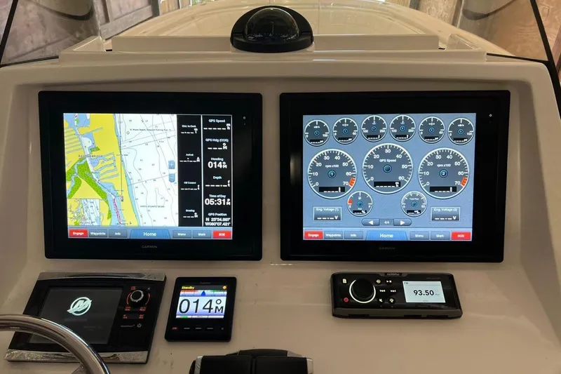 Slide: The Image of Dashboard of a 2016 Intrepid 327 Center Console with navigation and engine displays. - 7