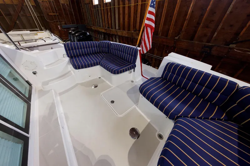Slide: The Image of 2011 Back Cove 37 boat interior with striped seating and American flag. - 13