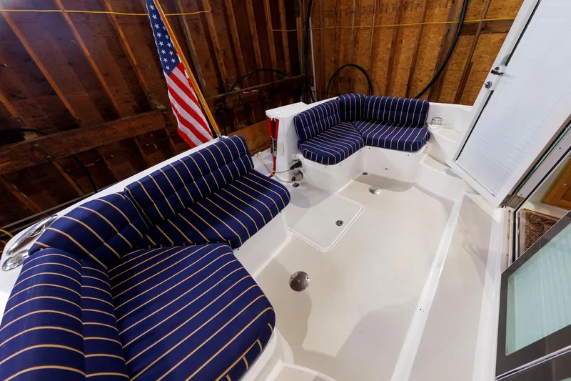 Slide: The Image of 2011 Back Cove 37 boat interior with striped seating and American flag. - 14