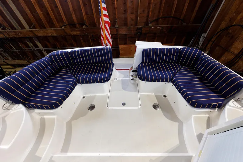 Slide: The Image of 2011 Back Cove 37 boat interior with striped seating and American flag. - 15