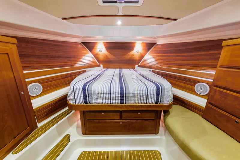 Slide: The Image of Luxurious cabin interior of 2011 Back Cove 37 yacht with wooden accents and cozy bed. - 16