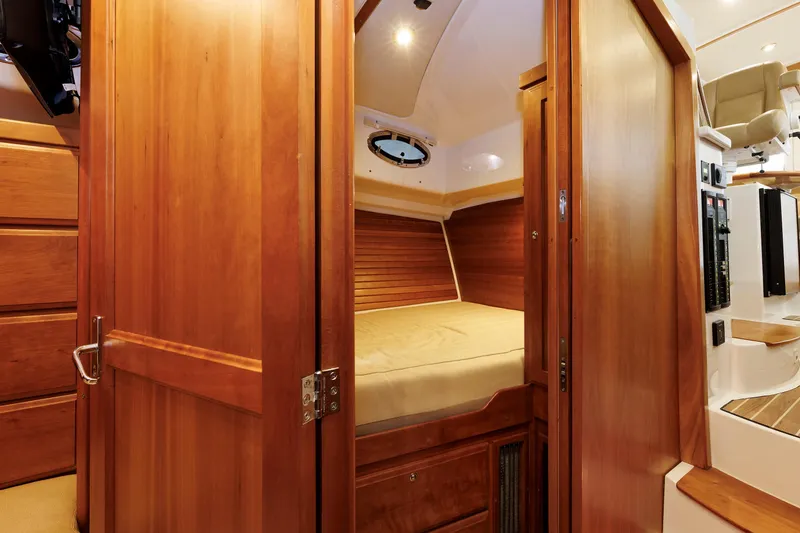 Slide: The Image of Interior cabin of 2011 Back Cove 37 yacht with wooden finishes and cozy sleeping area. - 21