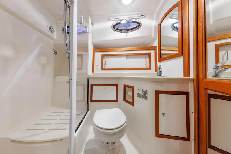 Slide: The Image of Luxurious bathroom in 2011 Back Cove 37 yacht with wood accents and modern fixtures. - 24