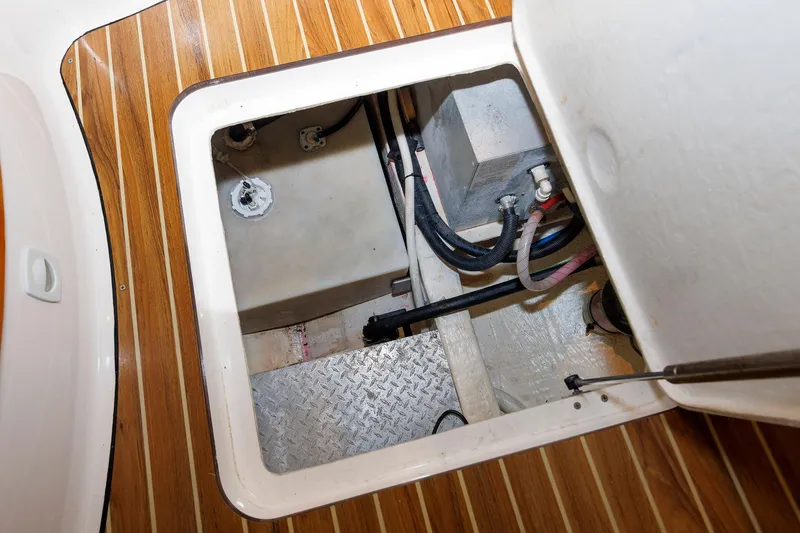 Slide: The Image of 2011 Back Cove 37 boat interior compartment with wooden flooring and visible wiring. - 26