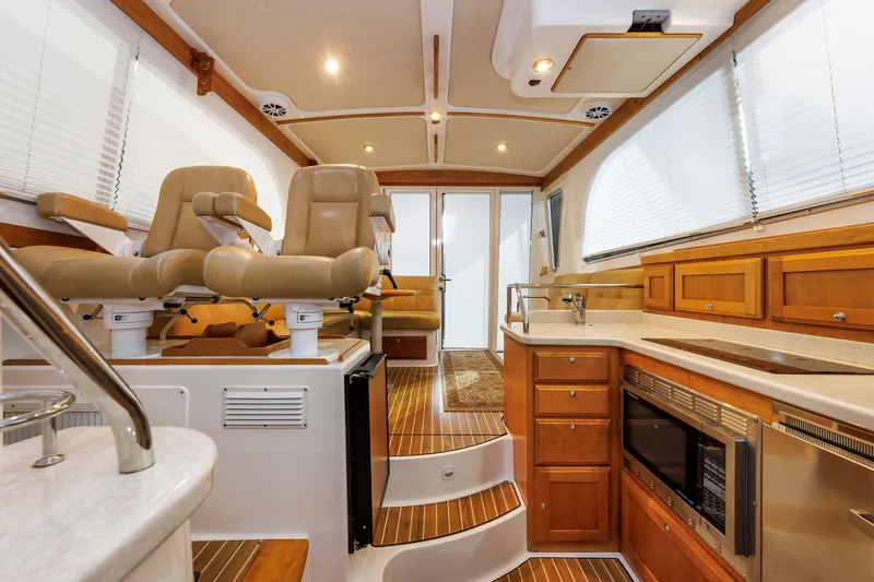 Slide: The Image of Interior of 2011 Back Cove 37 yacht with luxurious seating and modern kitchen amenities. - 28
